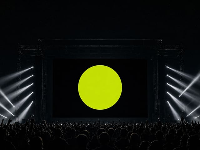 Concept artwork: a festival main stage with a chartreuse circle on the LED wall above a crowd.