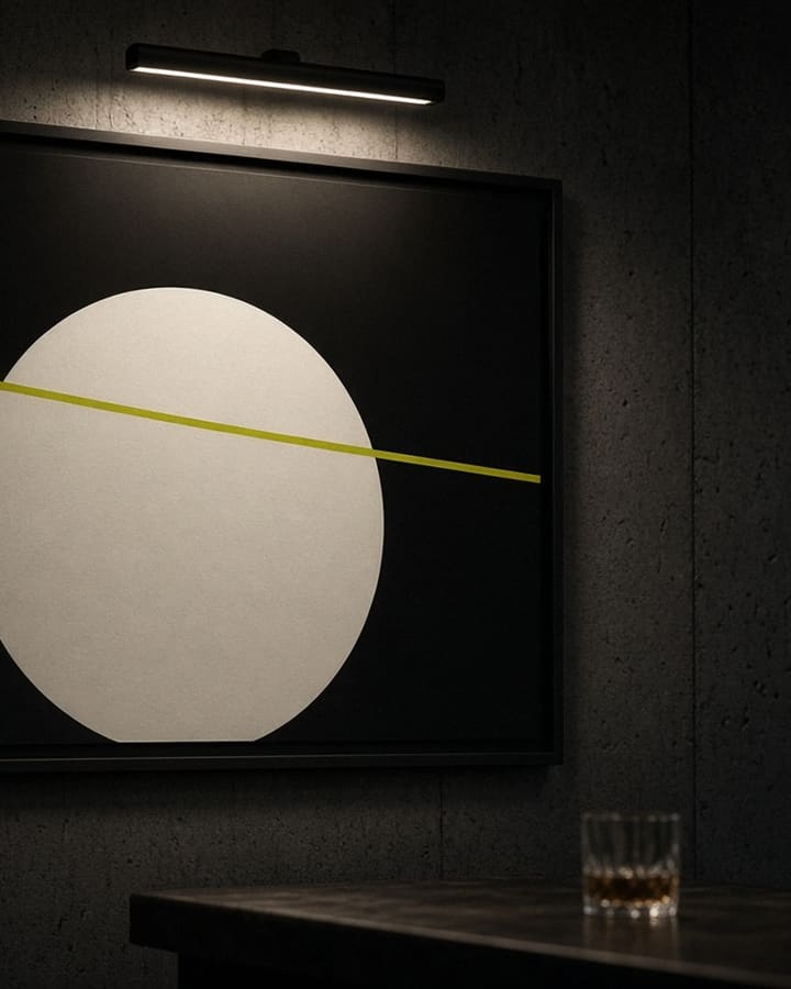 Concept artwork: a framed abstract poster under a picture light in a dark bar.